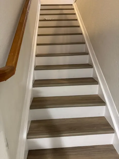 Upper flight of the staircase with new treads, after